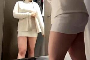 A hot girl is fucking in the fitting room, trying on clothes