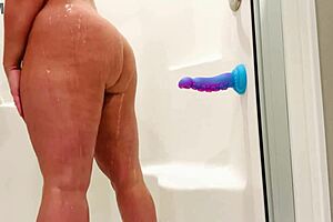 Milf teases with solo dildo play in steamy shower scene