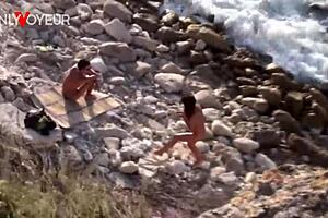 Beach voyeur catches horny chick with a stranger.