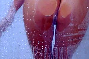 Gorgeous Tanned College Girl in Bikini Takes a Steamy Shower. Is She Teasing Her Friend or Just Getting Clean?