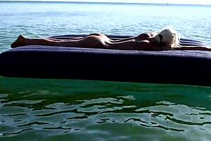check out this hot blonde with big boobs naked on the beach