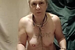 milf slave in bondage urinates with degradation belt and vibrator outdoors