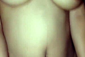 Indonesian woman with big natural tits enjoys a mature handjob and riding session on a huge cock during rainy weather outside.