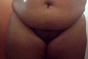 Hey, check out this chubby girl with a big butt stripping and showing her ass!