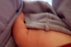 She touches herself while wearing pajamas in the bedroom.