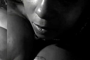 In the rhythmic beats, she oiled her black tits for a big black cock titfuck.