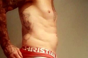 Blue-eyed guy flashes his big tattooed cock in a public USA shower