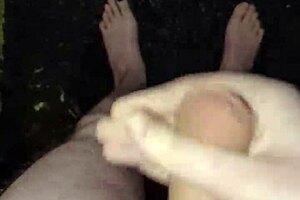 Masturbating his big cock naked in the pouring rain outdoors.