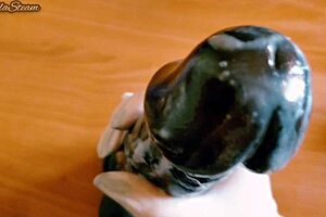 gloved strokes on big black dildo closeup